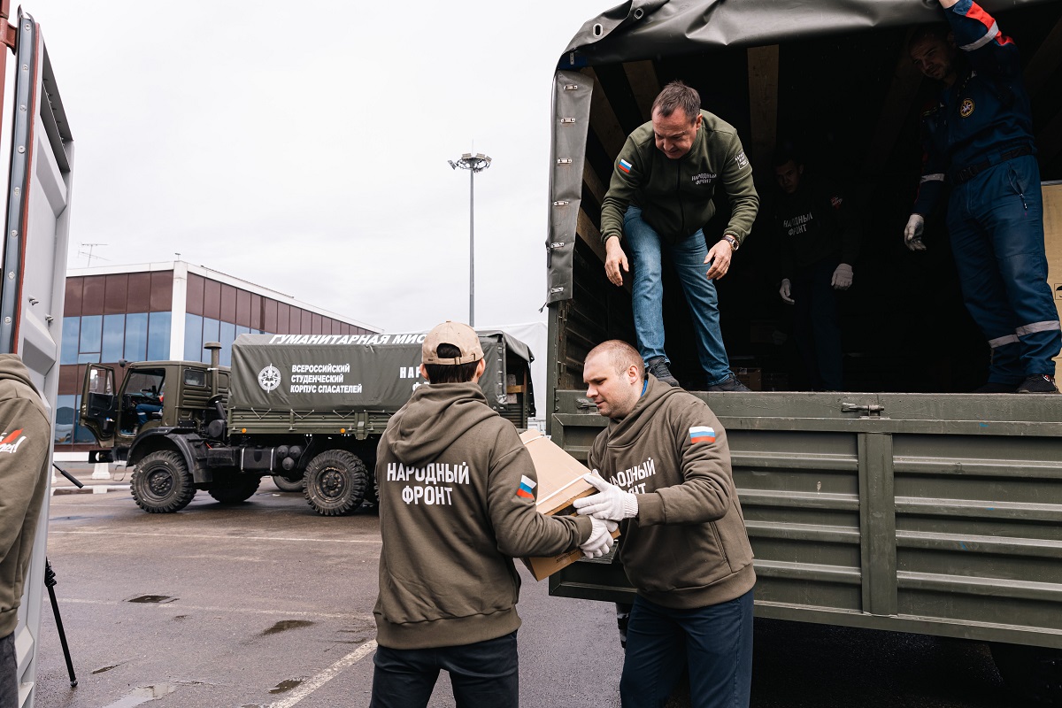 Волонтёры Народного фронта разгружают коробки с гуманитарной помощью